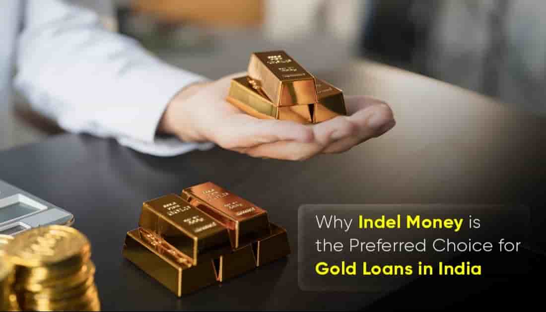 A person holding gold bars beside stacked coins and a calculator, representing Indel Money as a trusted gold loan company in India offering secure and reliable financial services.