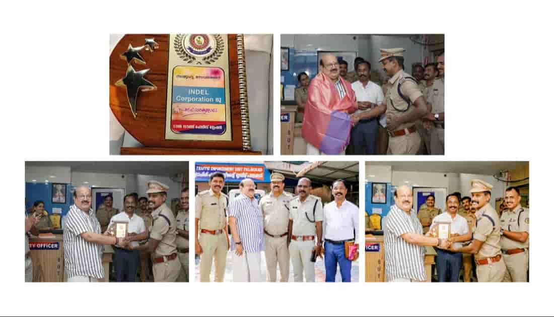 Indel Corporation representatives receiving recognition and award from Palakkad Police for their community commitment, with officers presenting a plaque during the event.